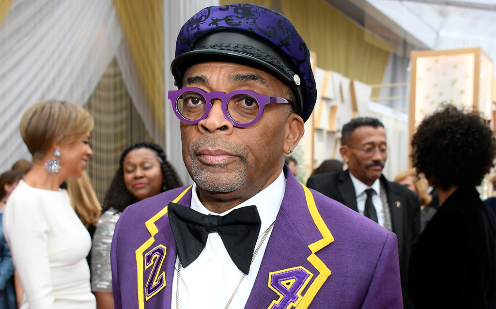 Presenter Spike Lee wore a custom Gucci purple two-button notch lapel Heritage suit with yellow trim and “24” patches on the lapel and back with a white evening shirt and black grosgrain bow tie. 