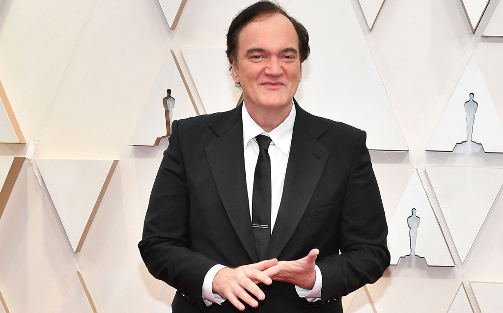 Quentin Tarantino wore a Gucci DIY MTO two-button satin notch lapel London tuxedo with a white covered placket-evening shirt, black leather lace-ups and a black satin bow tie. 