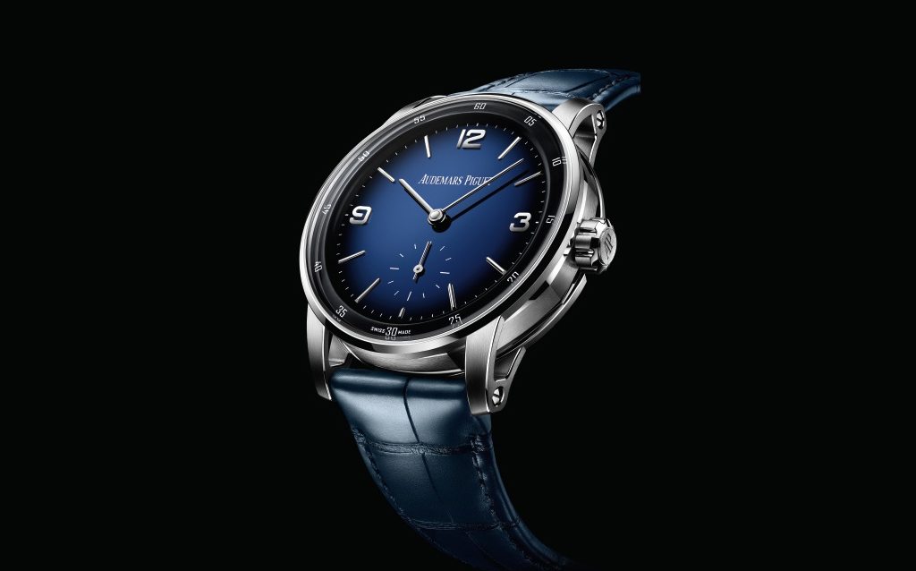 Code 11.59 Supersonnerie.  An exceptional minute repeater concept with a remarkable acoustic performance achieved  with gongs that are not attached to the main plate but to a new device acting as a soundboard. The striking mechanism regulator eliminates unwanted background noise. The case houses a hand-wound calibre 2953, and a smoked-blue enamel dial.
